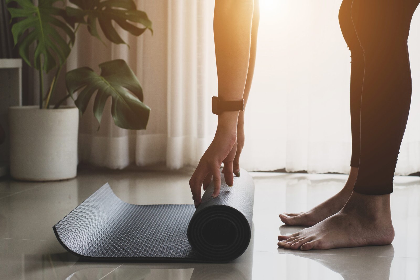young woman wearing black sport wear practicing yoga and meditat